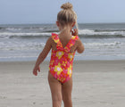 Child at the beach wearing the Snapper Rock UPF 50+ Swim Shorts - Flowers. Available from www.tenlittle.com