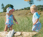 Child playing outside in the Snapper Rock UPF 50+ Swimsuit - Lighthouse Island. Available from www.tenlittle.com