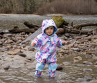 Child wearing Therm Kids All-Weather Fleece Onesie - Electric Floral. Available at www.tenlittle.com.