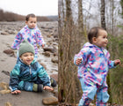 Close up Child wearing Therm Kids All-Weather Fleece Onesie - Electric Floral. Available at www.tenlittle.com.