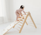 Child playing on the Piccalio Climber Pikler Triangle Set. Available from www.tenlittle.com