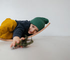 Child laying on the Piccalio Surfer Balance Board. Available from www.tenlittle.com
