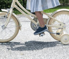 Girl on Bicycle wearing Ten Little Recycled Canvas Shoes - Navy Blue. Available at www.tenlittle.com