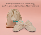 Front and side view of Ten Little Sherpa Baby Booties with a canvas bag, perfect for newborn gifts and baby showers. Available at www.tenlittle.com