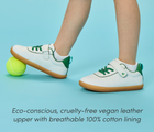 Side view child wearing Ten Little Centre Court Sneakers made with eco-conscious, cruelty-free vegan leather upper with breathable 100% cotton lining. Available at www.tenlittle.com
