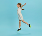 Child jumping wearing Ten Little Everyday Original - Neon Glow - Neon Yellow. Available at www.tenlittle.com