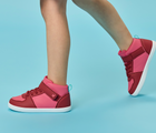 Side view child wearing Ten Little Varsity Mid Tops - All Star Pink. Available at www.tenlittle.com