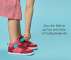 Side view child adjusting strap of Ten Little Varsity Mid Tops, easy for kids to put on and take off independently - All Star Pink. Available at www.tenlittle.com