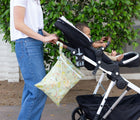 Bumkins Wet/Dry Bag - Camp Gear on stroller with woman pushing stroller with baby. Available from www.tenlittle.com