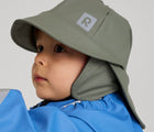 Close up of boy wearing Reima - Rain Hat - Greyish Green - Available at www.tenlittle.com