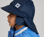 Close up side view of boy wearing Reima - Rain Hat - Navy - Available at www.tenlittle.com