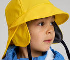 Close up of boy wearing Reima - Rain Hat - Yellow - Available at www.tenlittle.com