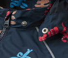 Close up hood snap buttons of Reima Reimatec Waterproof Jacket - Hete - Navy. Available at www.tenlittle.com
