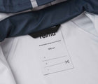 Close up name tag of Reima - Waterproof Rain Jacket - Navy - Available at www.tenlittle.com