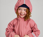 Child wearing Reima - Waterproof Rain Jacket - Rose Blush - Available at www.tenlittle.com