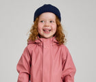 Child wearing Reima - Waterproof Rain Jacket - Rose Blush - Available at www.tenlittle.com