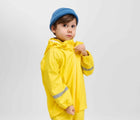 Boy wearing Reima - Waterproof Rain Jacket - Yellow - Available at www.tenlittle.com