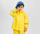 Boy wearing Reima - Waterproof Rain Jacket - Yellow - Available at www.tenlittle.com