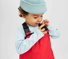 Child wearing Reima - Lammikko Waterproof Rain Pants - Reima Red - Available at www.tenlittle.com