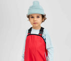 Child wearing Reima - Lammikko Waterproof Rain Pants - Reima Red - Available at www.tenlittle.com