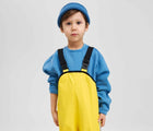 Child wearing Reima - Lammikko Waterproof Rain Pants - Yellow - Available at www.tenlittle.com