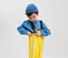 Child wearing Reima - Lammikko Waterproof Rain Pants - Yellow - Available at www.tenlittle.com