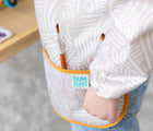 Close up of Bumkins Wander Long Sleeved Bib. Available from www.tenlittle.com.