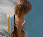 Boy at pool wearing Sunnylife Bubble Back Float - Seagull. Available at www.tenlittle.com