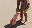 Child scooping sand with Sunnylife Sand Claw - Lobster. Available at www.tenlittle.com