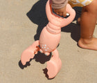 Child holding Sunnylife Sand Claw - Lobster. Available at www.tenlittle.com