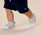 Child walking and wearing Ten Little First Walkers - Heather Oat. Available at www.tenlittle.com