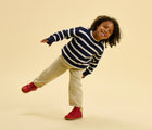 Child wearing Ten Little Furry High Top - Lava Red. Available at www.tenlittle.com
