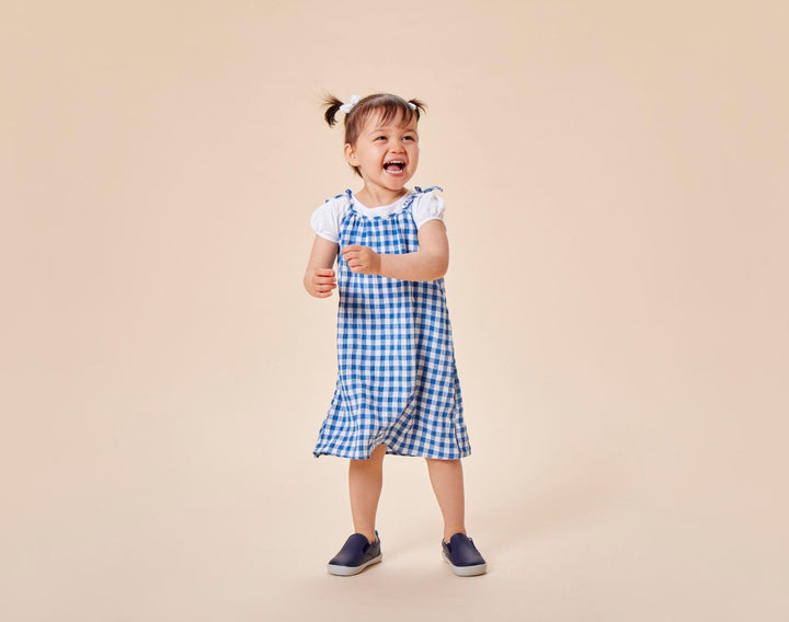 Child wearing Ten Little Slip-On Sneakers - Navy Blue. Available at www.tenlittle.com