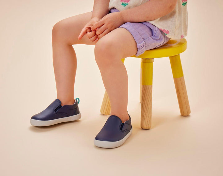 Girl wearing Ten Little Slip-On Sneakers - Navy Blue. Available at www.tenlittle.com