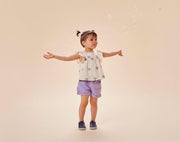 Child playing with bubbles wearing Ten Little Slip-On Sneakers - Navy Blue. Available at www.tenlittle.com