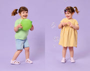 Split view of girl playing and wearing Ten Little Splash Sandals 2 - Lavender Purple. Available at www.tenlittle.com