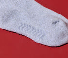 Close-up view of non-skid, BPA-free grips on Ten Little Cozy Socks. Available at www.tenlittle.com