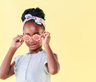 Child wearing Babiators Flower Sunglasses. Available from www.tenlittle.com