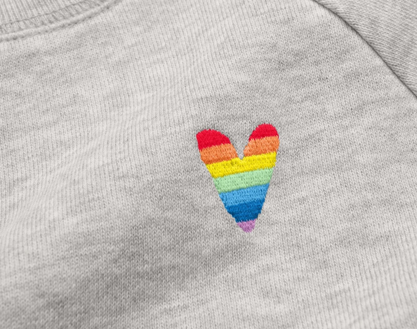 Close-up view of embroidered rainbow heart on Primary Adult Embroidered Sweatshirt - Rainbow - Gray. Available at www.tenlittle.com