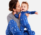 Mom holding baby wearing Primary - Baby 2-Pack Holiday PJs - Festive Lights - Available at www.tenlittle.com