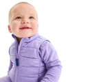 Baby sitting wearing Primary Baby Lightweight Puffer Vest - Iris. Available at www.tenlittle.com