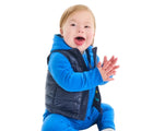 Baby sitting wearing Primary Baby Lightweight Puffer Vest - Navy. Available at www.tenlittle.com