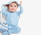 Baby sitting with blanket wearing Primary Baby Onesie PJs - 2 Pack - Steam Sheep. Available at www.tenlittle.com