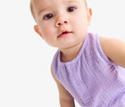 Baby wearing Primary Baby Sleeveless Romper - Iris. Available at www.tenlittle.com