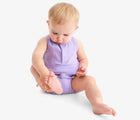 Baby sitting wearing Primary Baby Sleeveless Romper - Iris. Available at www.tenlittle.com