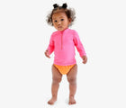 Baby wearing Primary Swim Diaper - Cantaloupe. Available at www.tenlittle.com