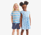 Child wearing Primary Chino Drawstring Shorts - Sunwashed Navy. Available at www.tenlittle.com