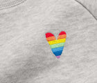 Close-up view of embroidered rainbow heart on Primary Embroidered Sweatshirt - Rainbow - Gray. Available at www.tenlittle.com