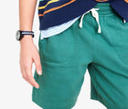 Child wearing Primary Gym Shorts - Sunwashed Teal. Available at www.tenlittle.com