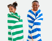 Kids wearing Primary Hooded Towel - Assorted Colors. Available at www.tenlittle.com